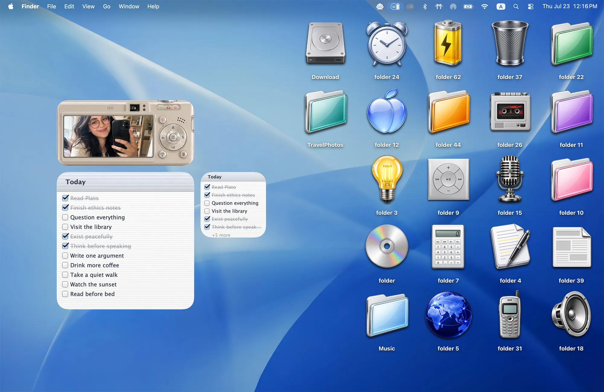 Y2K Aesthetic MacBook wallpaper in glossy blue with retro 2000s folder icons like a CD, a flip phone and a light bulb, plus a digicam photo widget and to-do list